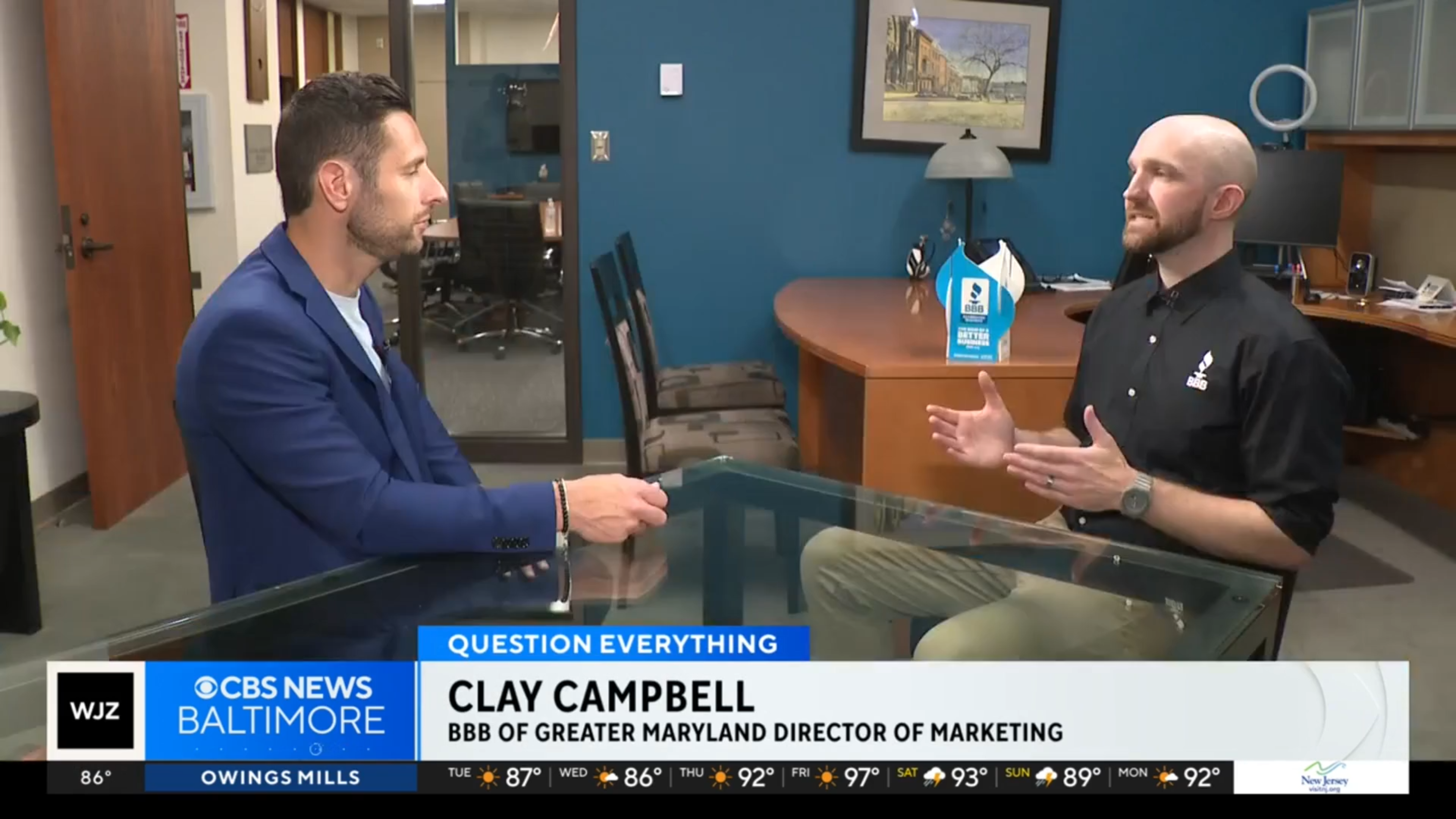 A WJZ-TV reporter interviewing Clay in an office.